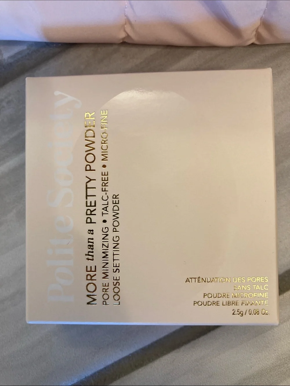 Polite Society lip plump, setting powder, and bag